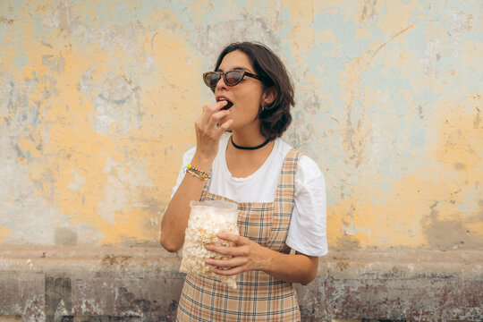 Woman eating popcorn
