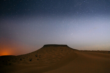 Night view of the stars over the Tembaine mountain in Sahara desert
