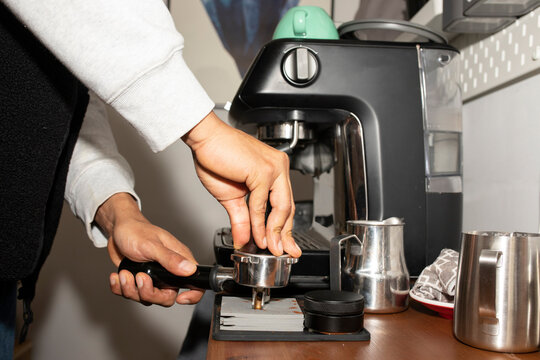 Anonymous man making coffee with coffee tools