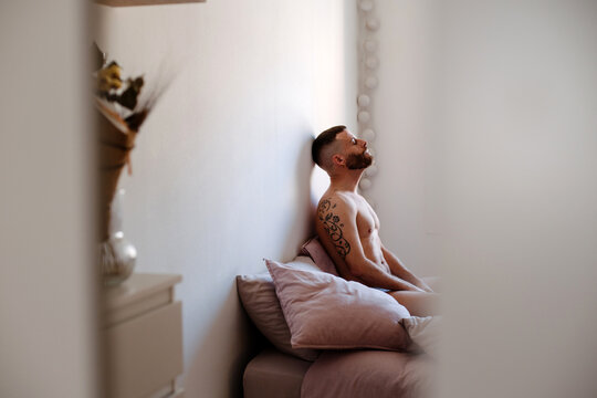 Pensive man alone in his bed