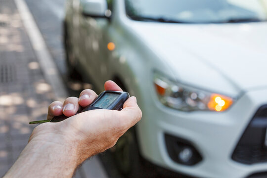 Anonymous owner locking automobile with keyless entry on street