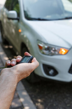 Unrecognizable driver using remote entry against automobile on street