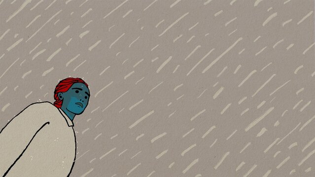 woman standing at the left of the frame while it is raining.  