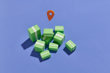 A pile of cardboard boxes and a red position pin.