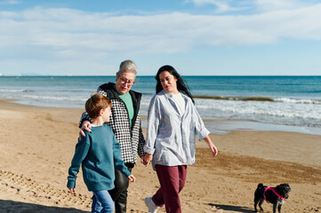 Smiling multigenerational family walking on a beach