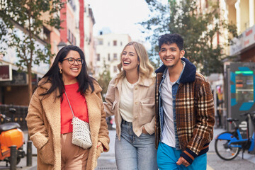 Group of friends walking together and engaged in conversation.