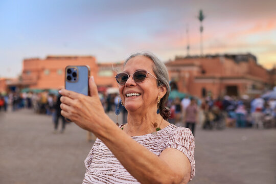 Older woman takes photos with cellphone in Marrakesh 