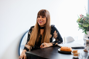 Cheerful businesswoman breakfast time at office