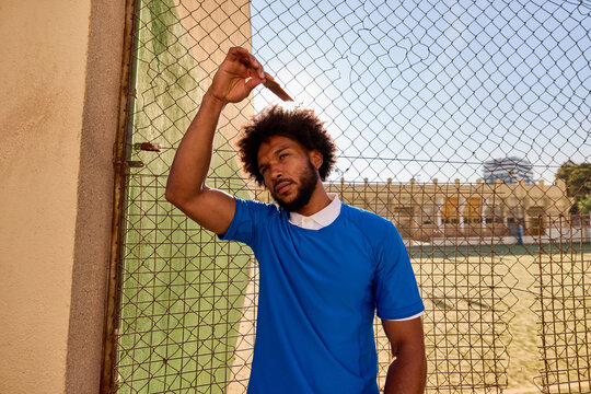 Black male football player combing hair