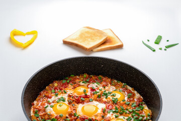 Ready Fried eggs with vegetables and bread, top view. Recipe and cooking process for Shakshuka and Menemen.