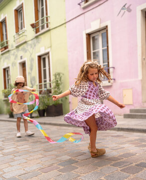 Little girl dancing in a colourful street.