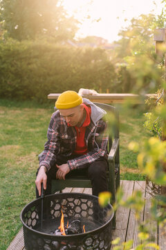 Man siting near bonfire 