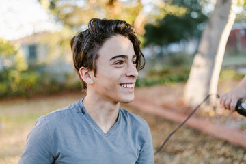 Teen happy boy with new haircut outdoor