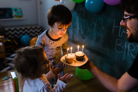 Boy blows out candles for his fourth birthday