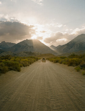 Car Driving down Dirt Road