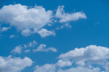 Naklejka na ściany i meble Natural background of blue sky and white clouds. Beautiful high summer sky
