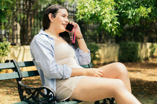 Transsexual woman sitting talking on the phone.