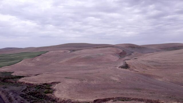 A drone surveys a bare, fallow wheat field in the Palouse region of Eastern Washington 4K 60FPS 