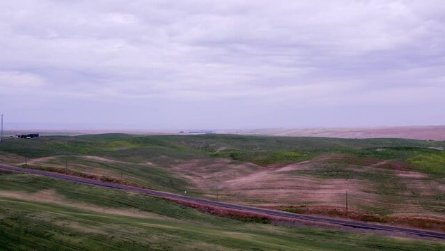 A drone rises over dry land wheat fields of the Palouse region of Eastern Washingon 4K 60FPS