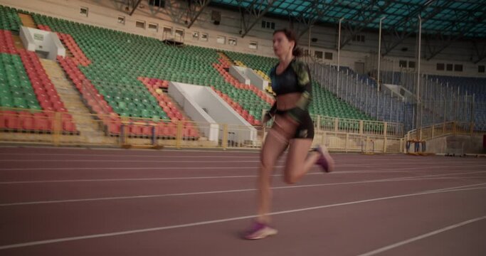 Strong female sprinter starting out of block
