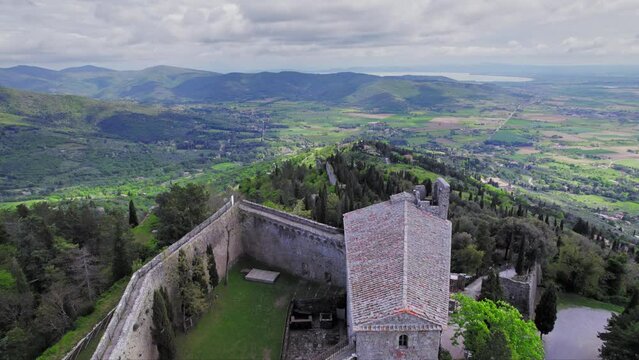 Forward aerial over Fortress of Girifalco and green nature in Tuscany