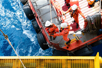 Fototapeta na wymiar Offshore oil and gas platform during crew boat transfer worker to the platform during sunset time