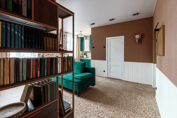 Entrance hall in a modern apartment made in retro style with bookshelves and a green pouf and a sofa