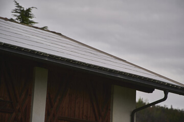 residential solar photovoltaic system. PV converts sunlight directly into electricity. Solar cells. Beautiful house with solar panels outdoors. Real estate for rent.