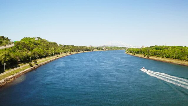 Drone flight over Cape Cod Canal towards the steel arch Sagamore Bridge