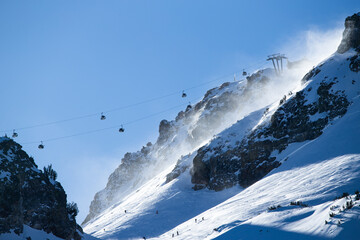 Wind Blowing Snow on Ski Hill with Gondola Overhead