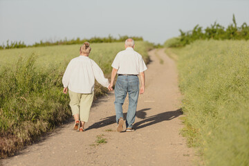 elderly people walk in nature country life, people from behind