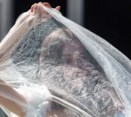 Young beautiful bride in a white wedding dress and veil on her wedding day