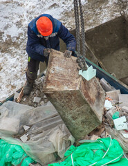 Unloading garbage at a construction site with a crane