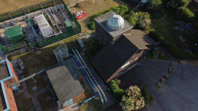 Aerial view circling Pex hill Leighton observatory silver dome rooftop on hilltop farmland at sunrise