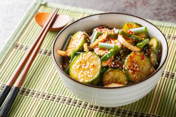 Easy Spicy Korean Cucumber Salad Oi Muchim made with garlic, onion, sesame and hot peppers on the table. Horizontal