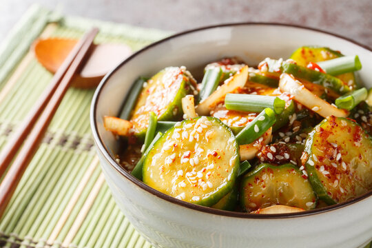 Homemade Oi muchim is a Korean spicy cucumber salad mixed with seasonings closeup on the bowl on the table. Horizontal