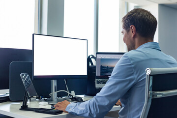 Rear view of young man businessman broker agent in shirt working using pc computer at desk in...