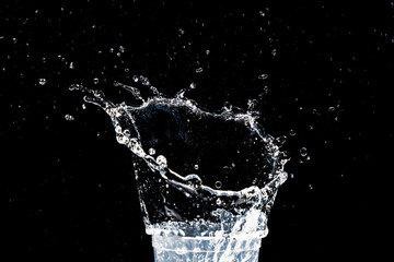 water splash in a glass. water splash isolated on black.