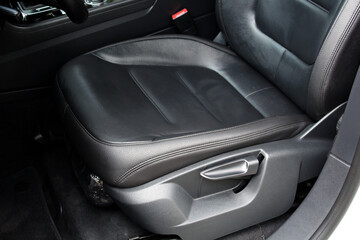Modern luxury car black leather with alcantara interior. Part of black leather car seat. Interior...