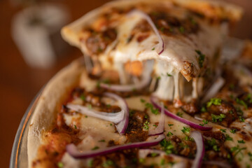 Delicious Thin Crust Pizza with Melty Cheese, Beef Barbacoa, and Red Onion