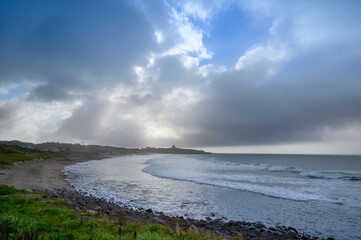 Sea waves and sky clouds. Dramatic landscape at dusk. The Fugui Cape Lighthouse in Shimen. Taiwan