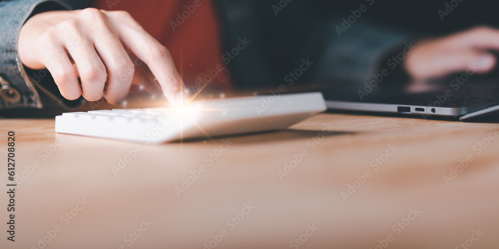 Aufkleber Businessman using a calculator to calculate numbers ,profit and loss statement review of company performance ,Cost analysis and calculation of financial documents ,business account checking