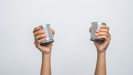 Hand holds canned food isolated on white, woman hands.