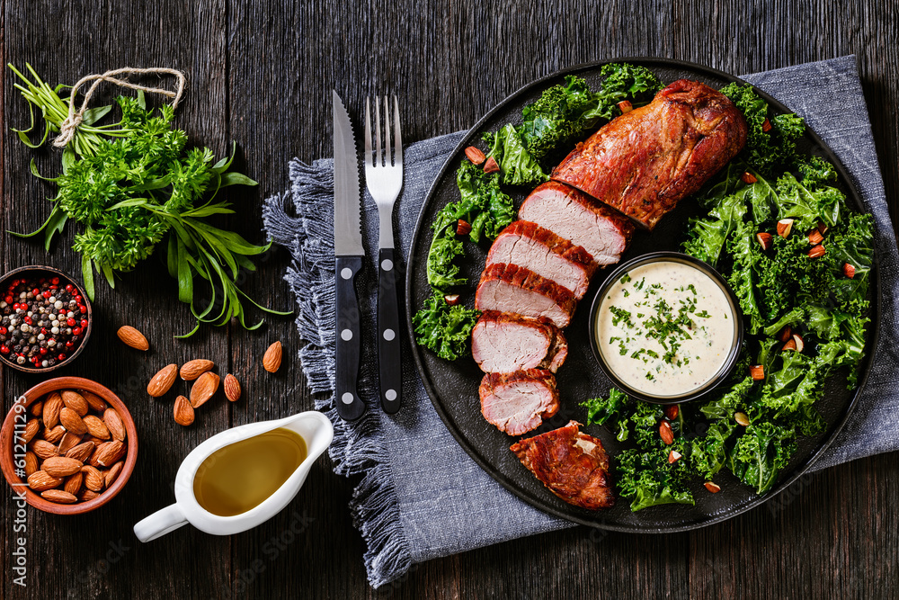 Poster roast pork tenderloin with kale salad and sauce