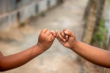 A young man shows his both hand with signs of love and a background blur