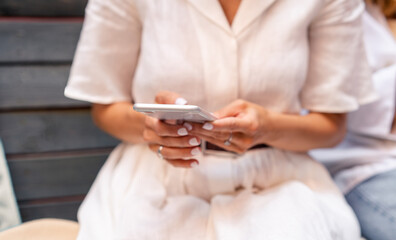 Female using mobile device, text message or surfing social media. Using phone in hands