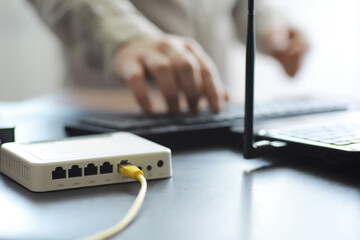 Modern dual band wireless router. Man working in the background. Fast and wireless internet concept.