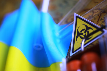 Ukrainian flag biohazard and test tubes. Assistance to Ukraine in biolaboratories. Western...