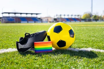 Poster Rainbow colors of gay pride for fight for rights of LGBTQ people collective in soccer. Homosexuality and transsexuality in sport. Football equipment with captain's armband of the pride flag. © Clàudia Ayuso