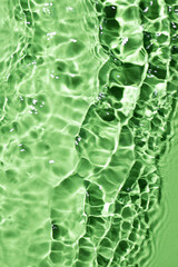 Light green water surface texture with splashes and bubbles. Abstract background for natural beauty...